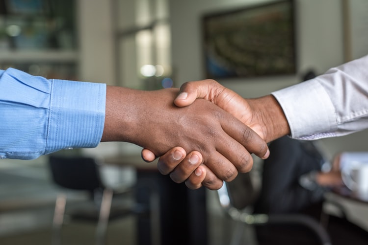 two people shaking hands after a job interview