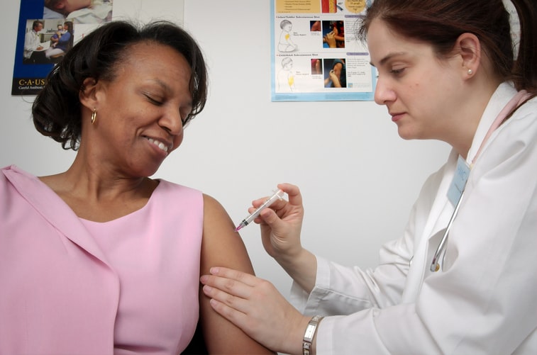 Nurse Administers Vaccine To Patient